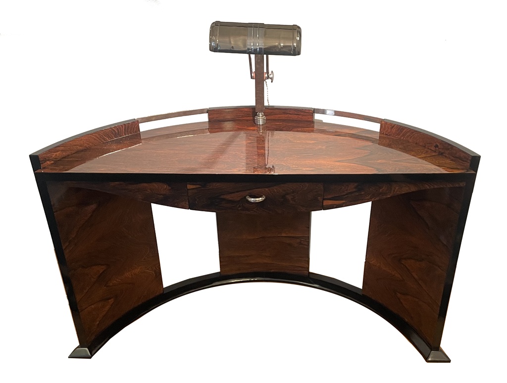 Semicircular desk viewed from the front, showing its curved supports and central lamp