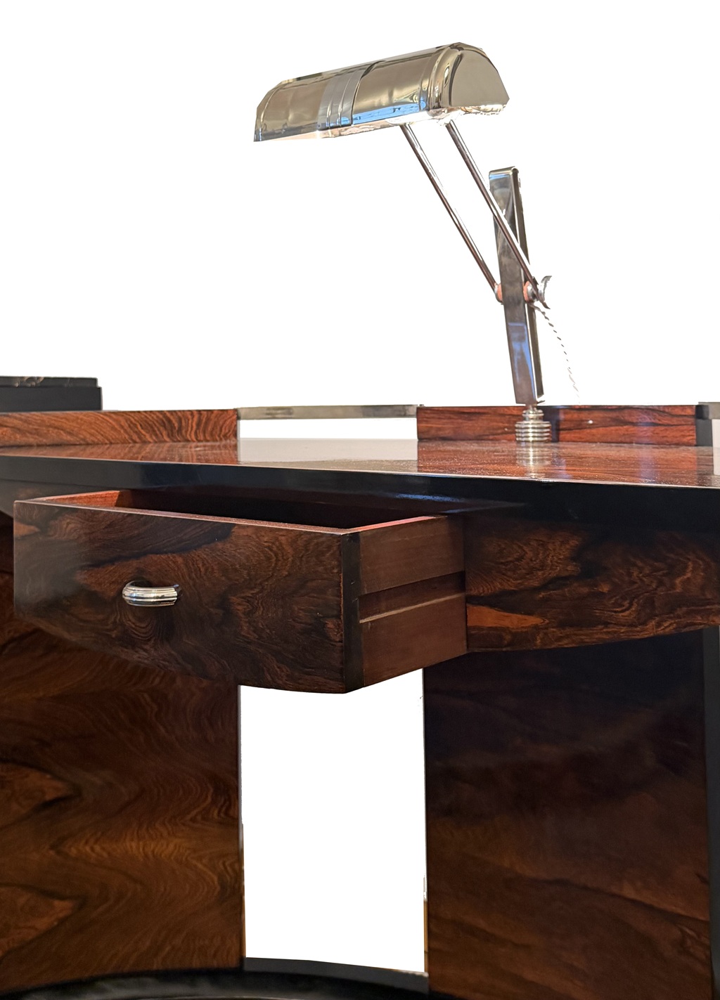 Close-up of the desk’s single drawer beneath the top and its integrated adjustable lamp