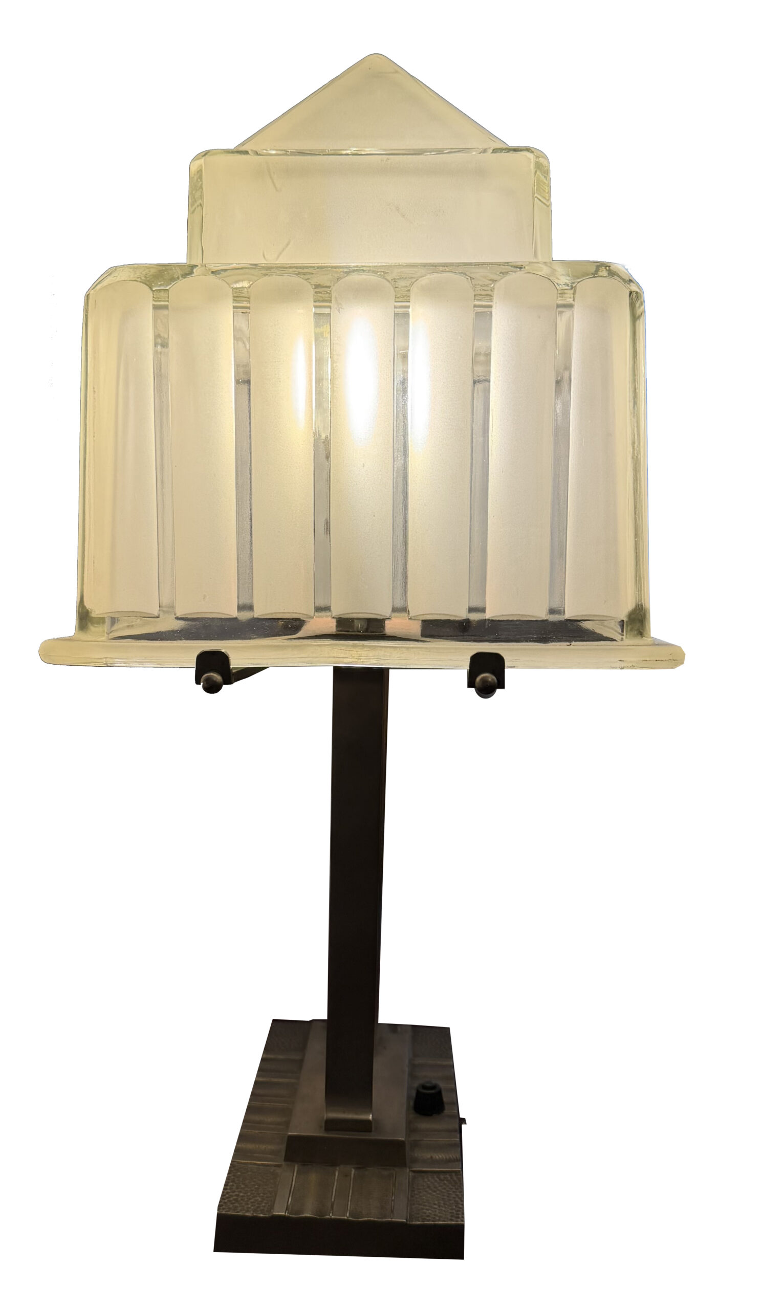 Side view of the table lamp with its ribbed glass shade and figural stem
