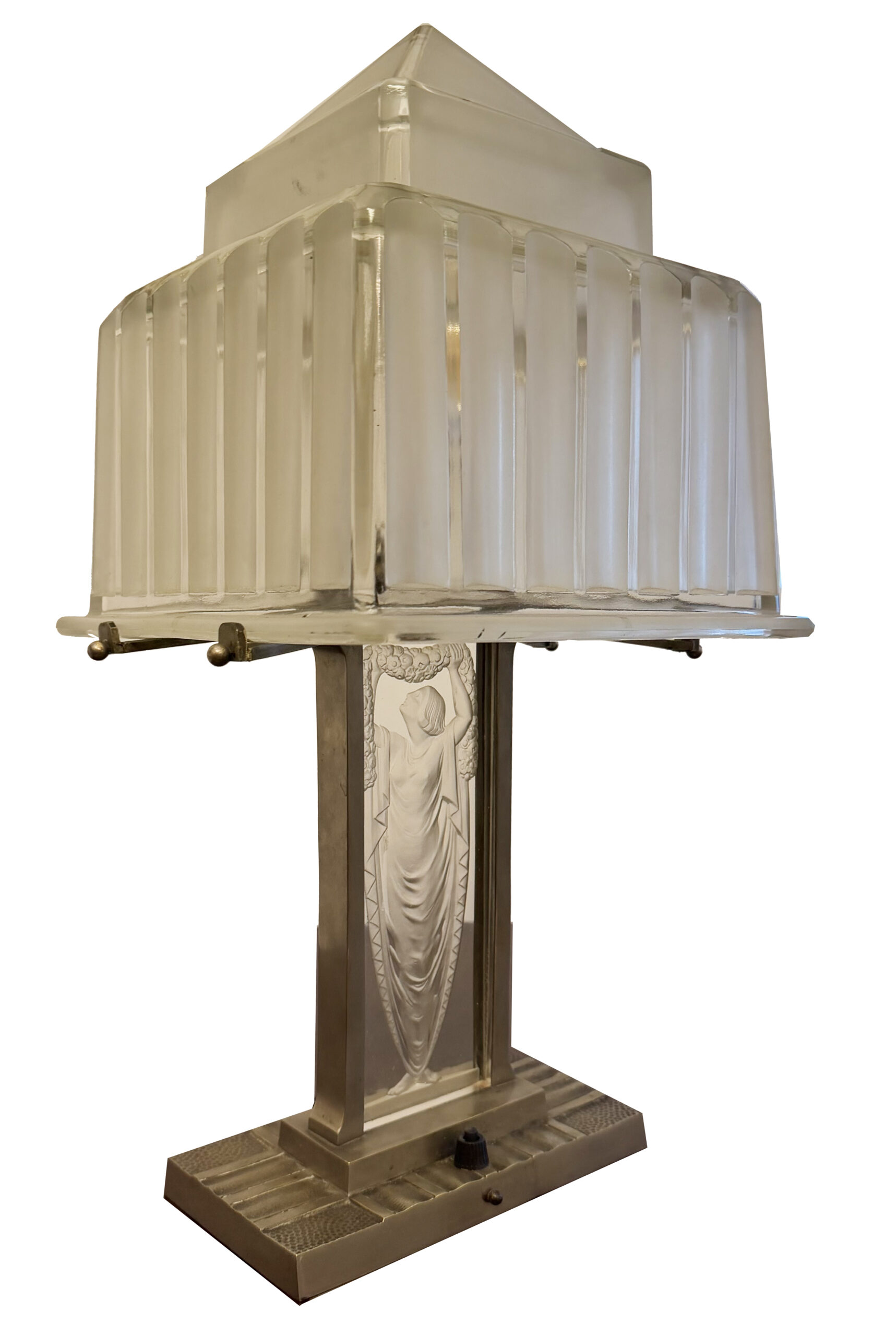 Illuminated table lamp with a softly glowing ribbed shade and female figure in relief