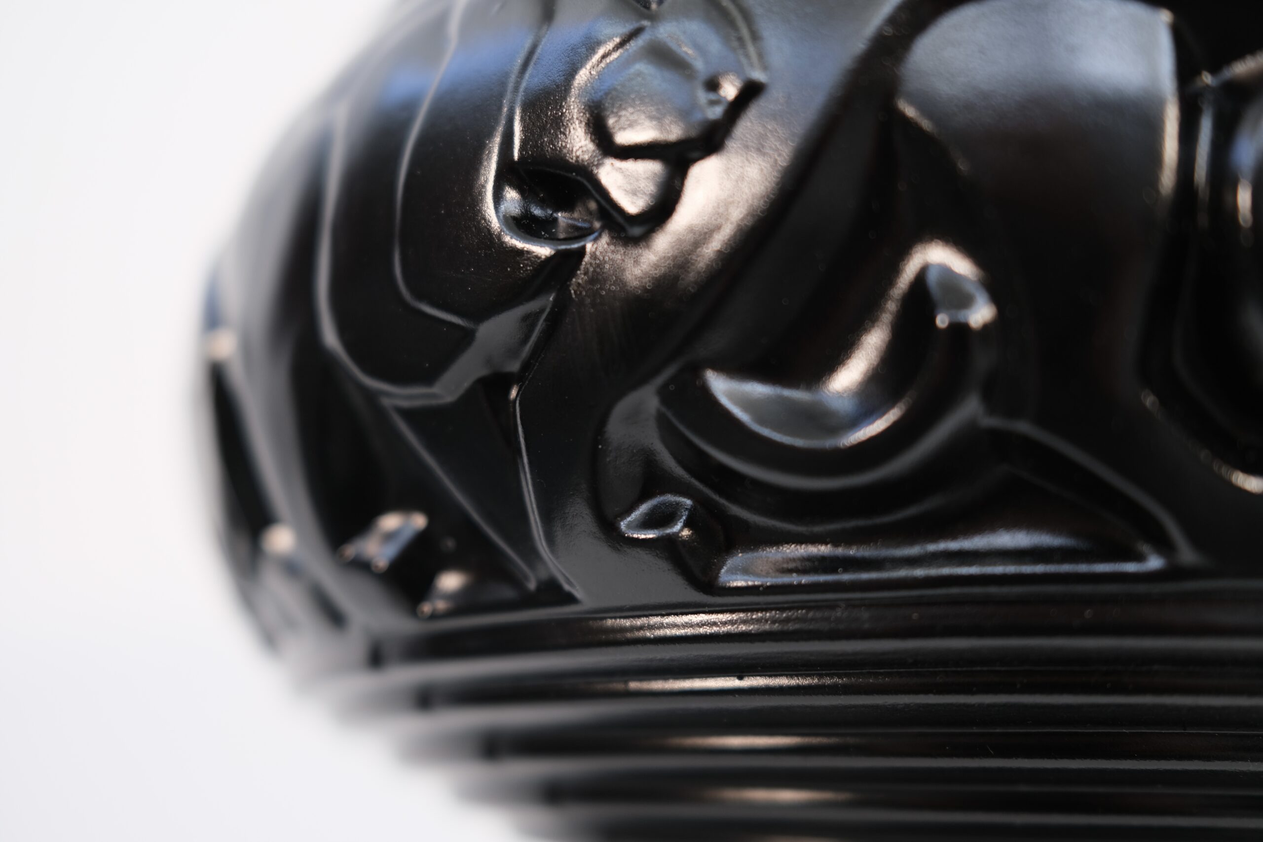 Detail of a striding lion and the moulded bands near the foot of the vase